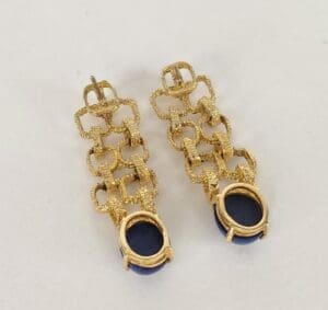 Gold chain earrings with blue stones.