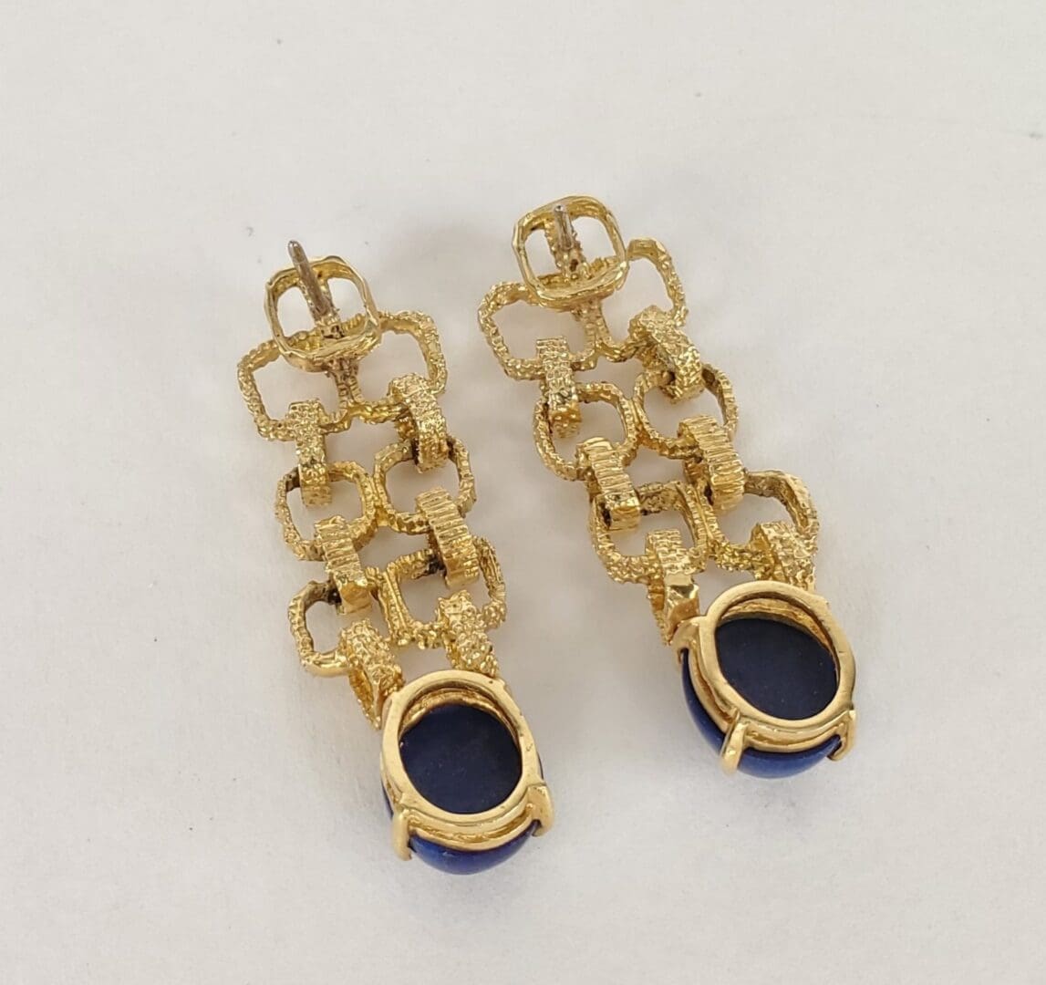Gold chain earrings with blue stones.