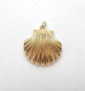 Gold seashell-shaped pendant on white background.