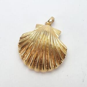 Gold shell-shaped pendant on white background.