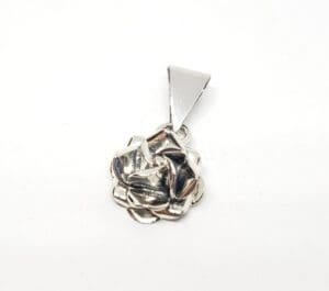 Silver rose-shaped pendant with triangular bail.