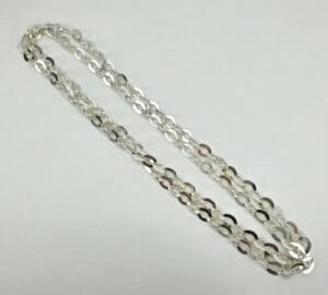 Silver chain necklace on white background.