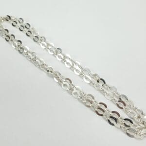 Silver chain necklace on white background.