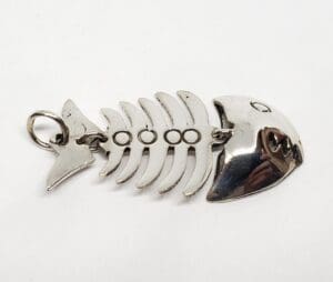 Metal fishbone-shaped keychain on white background.