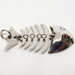 Metal fishbone-shaped keychain on white background.
