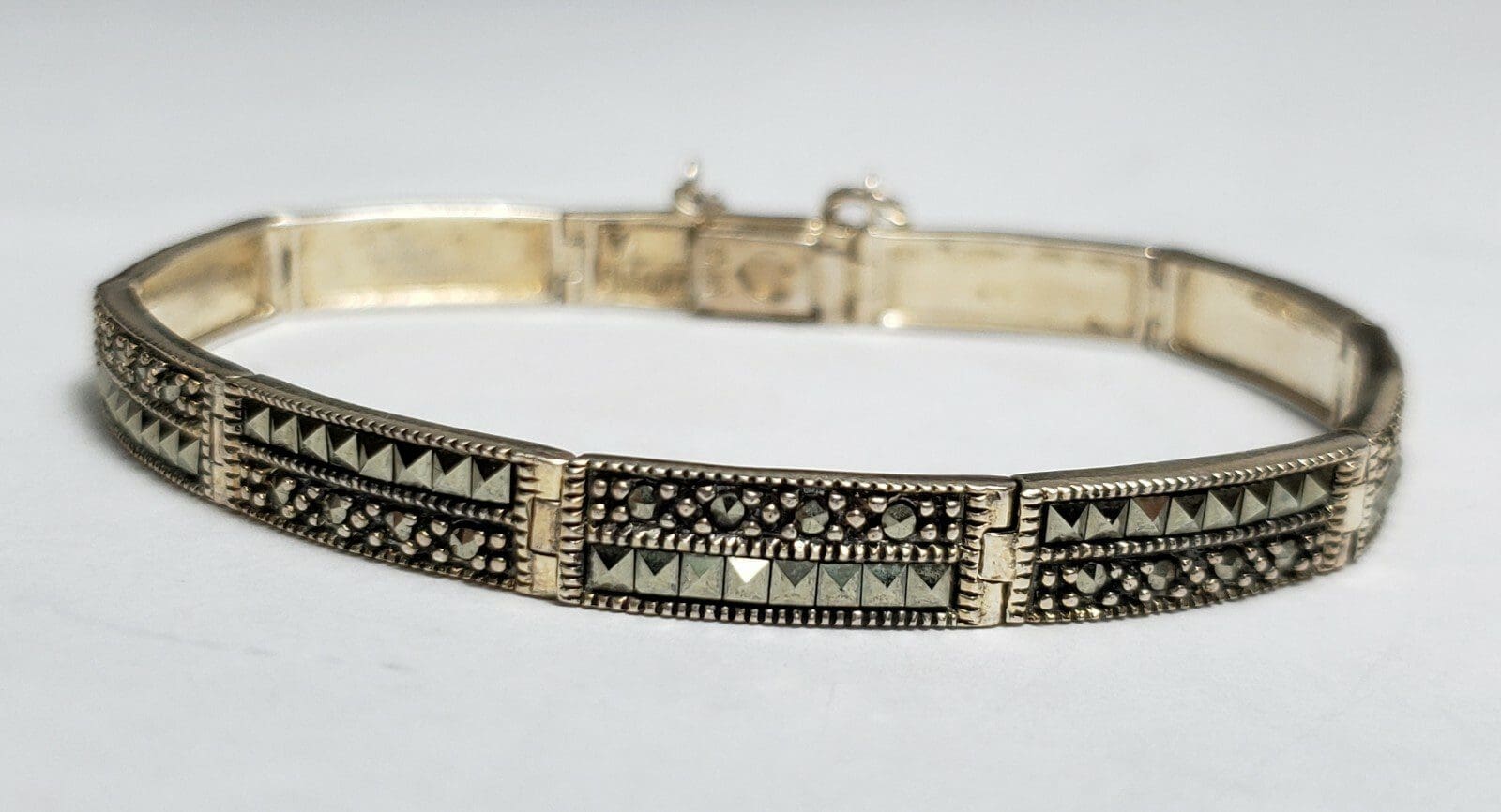 Silver bracelet with intricate geometric design.