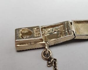 Silver clasp with heart and Thailand markings.
