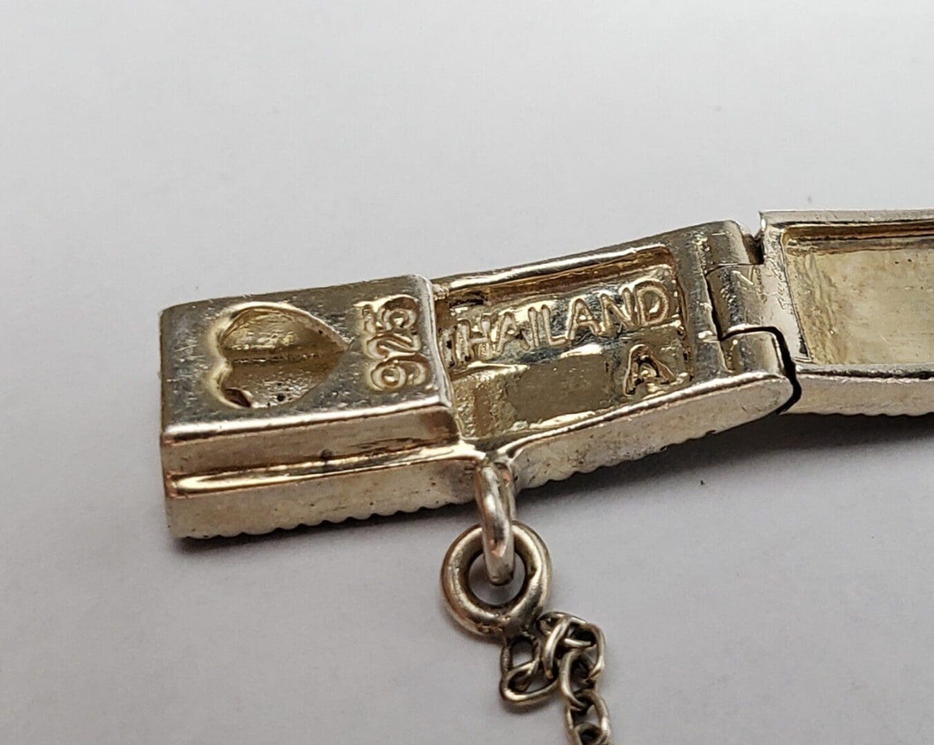 Silver clasp with heart and Thailand markings.