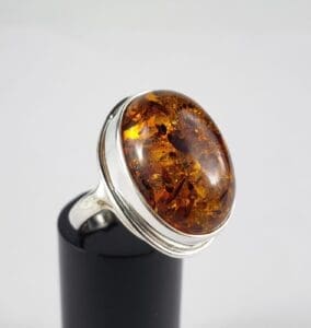 Amber gemstone ring on silver band.