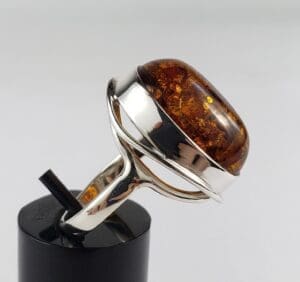 Silver ring with large amber gemstone.