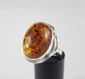 Amber gemstone ring with silver band.