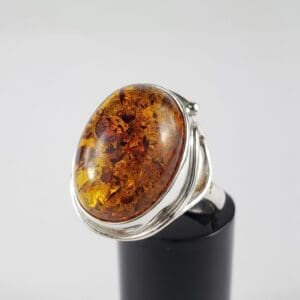 Amber gemstone ring with silver band.
