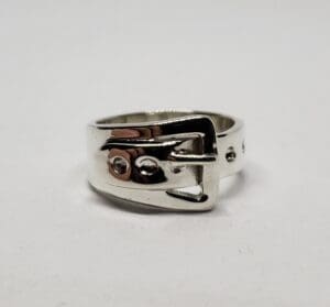 Silver ring with buckle design.