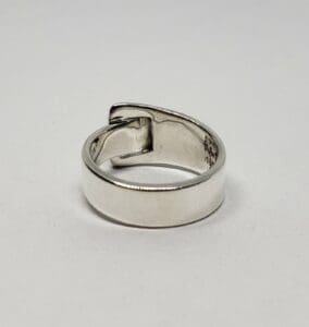 Silver adjustable ring on white background.
