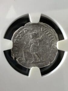 Ancient coin in protective display case.
