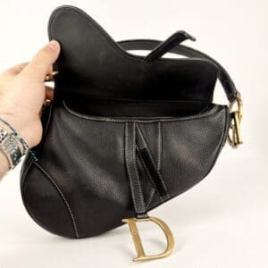 Black leather handbag with gold details.