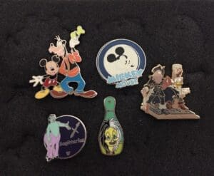 Various collectible pins on black background.