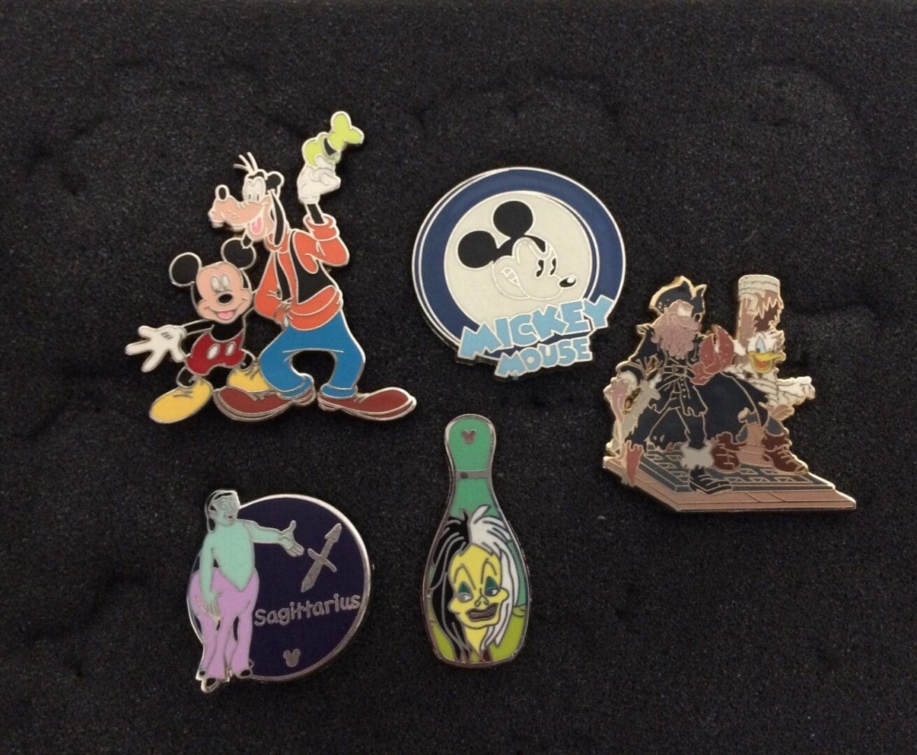 Various collectible pins on black background.