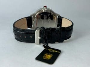 Black leather watch with brand tag.