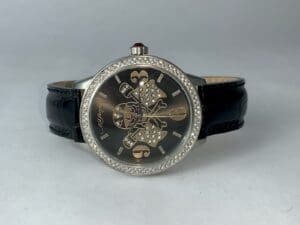 Luxury watch with black leather strap.