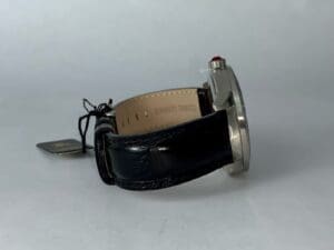 Silver watch with black leather strap side.