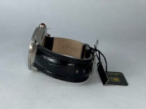 Luxury watch with black leather strap.