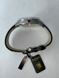 Wristwatch with leather strap and tags.