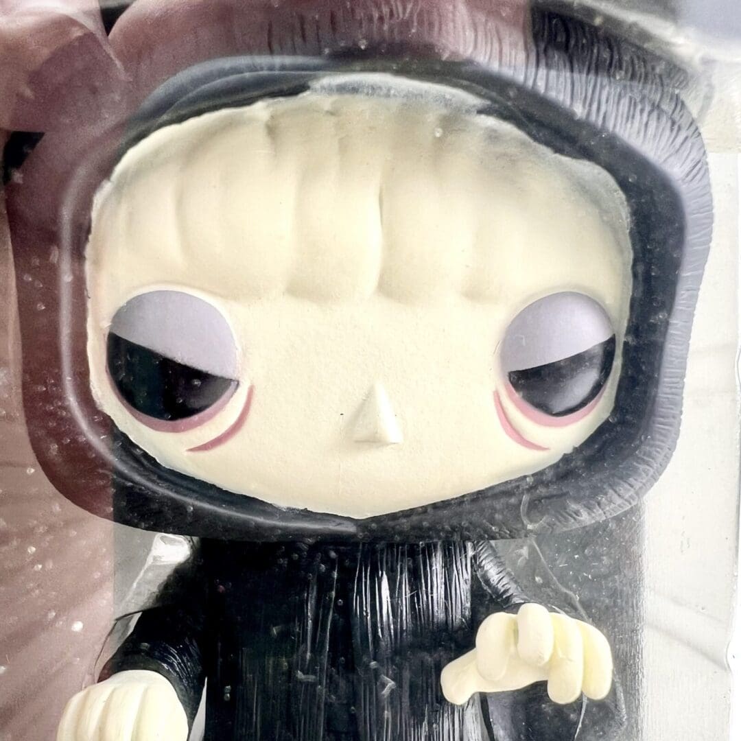 Funko Pop figurine in a black hood.