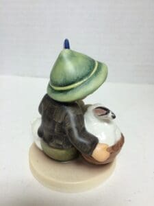 Figurine of child holding a white lamb.