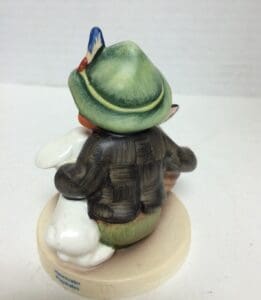 Figurine of child with green hat.