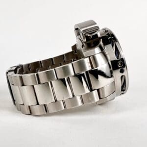 Silver metal watch with a stainless steel bracelet.