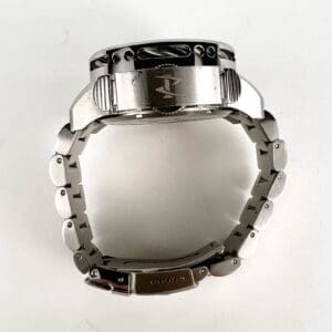 Silver wristwatch with metal strap, side view.