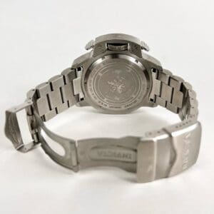 Silver wristwatch with open metal clasp.