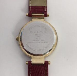 Back of wristwatch with maroon strap.