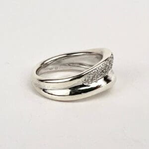 Silver ring with textured design on band.