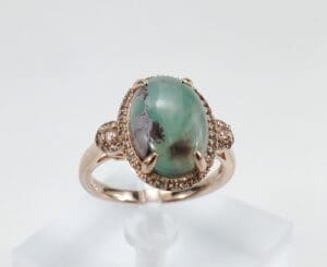 Gold ring with a large turquoise stone.