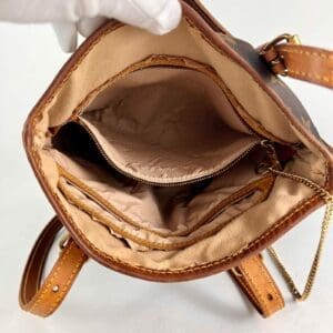 Open brown leather bag with compartments.