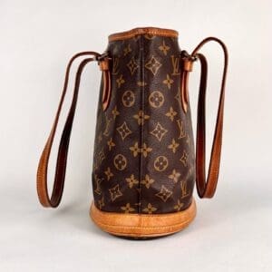 Luxury monogrammed handbag with leather straps.