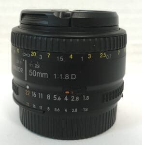 Camera lens with focus and aperture markings.