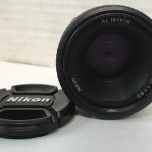 Nikon camera lens and lens cap.