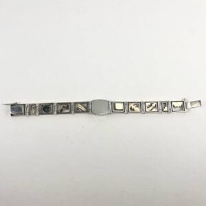 Silver bracelet with engraved square links.