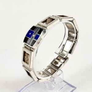Silver bracelet with geometric inlay design.