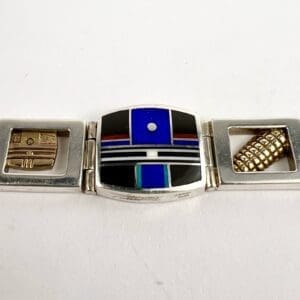 Silver bracelet with colorful geometric designs.