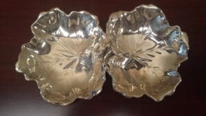 Silver leaf-shaped decorative dish on table.