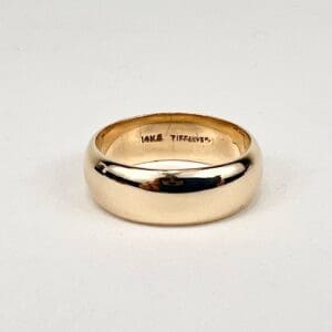 Gold ring with engraved inscription inside.