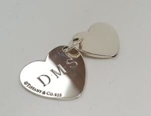 Silver heart-shaped Tiffany & Co. charm.