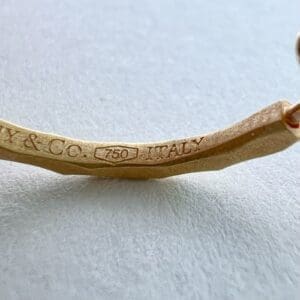 Gold jewelry with "750 Italy" engraving.