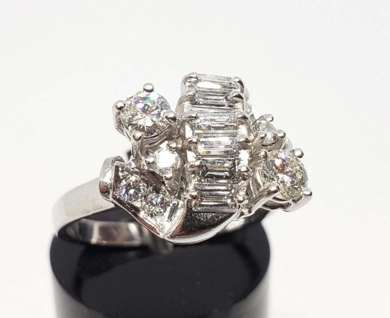 Silver ring with multiple sparkling gemstones.