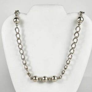 Silver chain necklace with large beads.