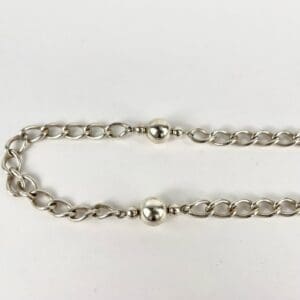 Silver chain bracelet with round beads.